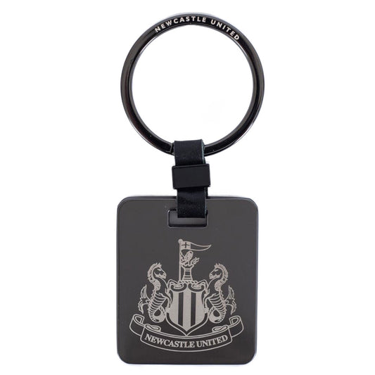 Brushed gunmetal finish with a black leather link attachment and split ring, features the NUFC crest in a subtle grey