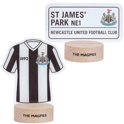 LED desk light with a wooden base and clear plastic insert featuring a Newcastle shirt and street sign