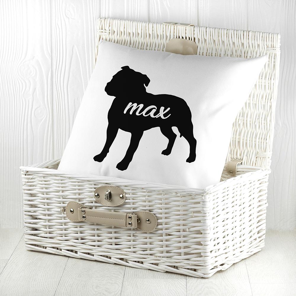 White cushion with black silhouette of a staffordshire bull terrier personalised with name photographed inside a white wicker basket  By Sweetlea Gifts